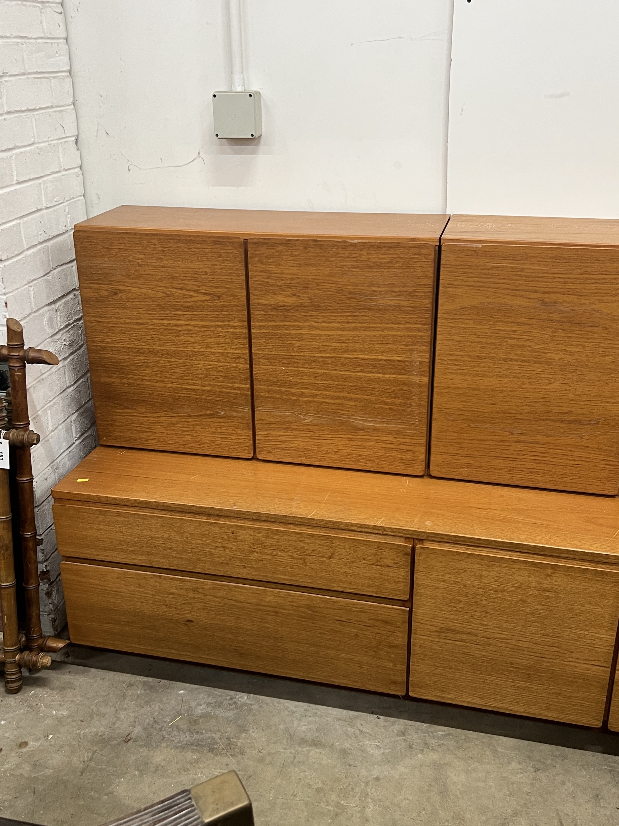 A mid century teak side cabinet width 168cm, depth 53cm, height 108cm, a similar glazed side cabinet and a ladder system bookcase.